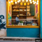 베이루트의 숨겨진 명소 - A vibrant urban scene in Beirut&rsquo;s Mar Mikhael district at dusk, featuring colorful street murals and...